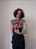 male model in a tight laced corset and shibari rope