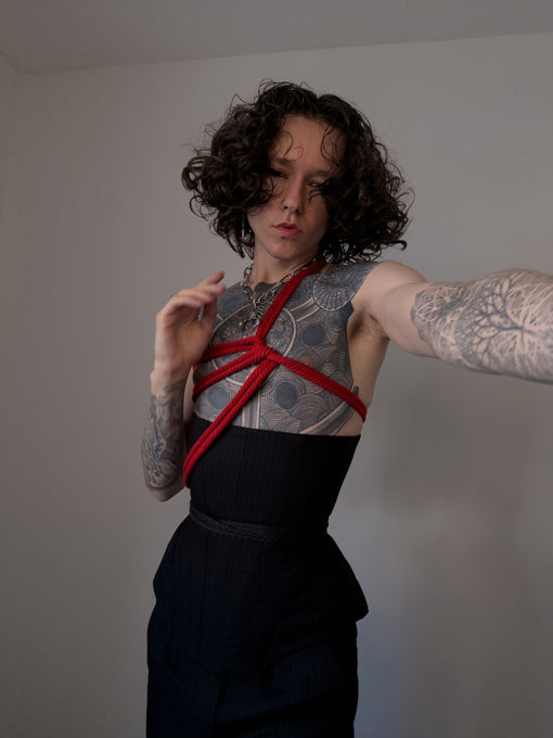 Male model in a corset with shibari rope
